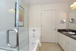 Master en suite has walk-in glass shower, bathtub and dual sinks. 